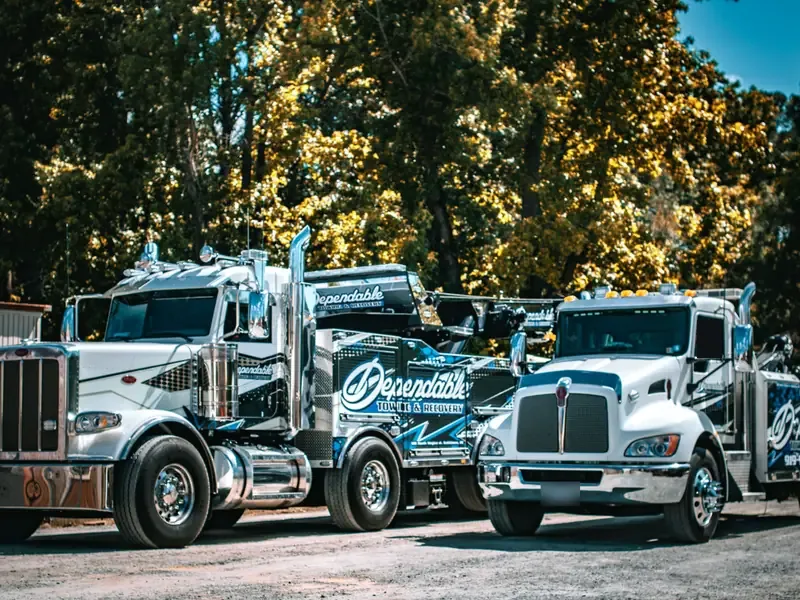Dependable rotator and wrecker parked side by side at the yard
