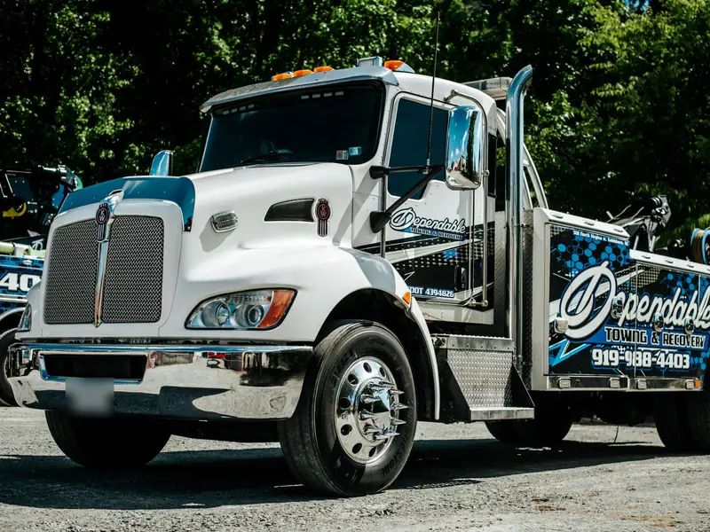 Dependable Towing & Recovery wrecker parked on a gravel lot